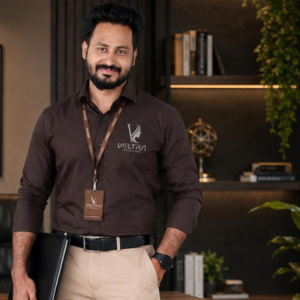 About Muhammed Aslam, Sales & Marketing Head at Veltra Professional, standing confidently in a professional office environment.